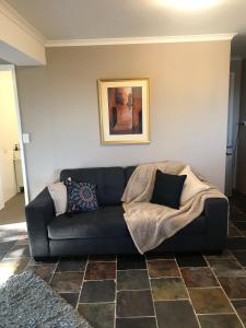 a living room with a couch with a blanket at Robinson Retreat in Darlington