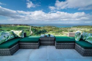 a patio with wicker furniture and a view of the ocean at Le Tanger Résidence Hôtelière in Tangier