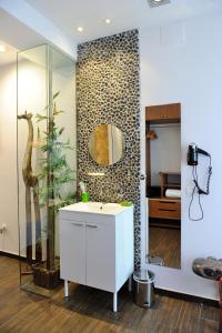 a bathroom with a sink and a mirror on a wall at Hotel Boutique Sabbia Valencia in Valencia