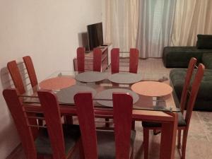 a dining room table with red chairs and a dining room at Просторен и добре обзаведен апартамент Oborishte 39 str in Plovdiv