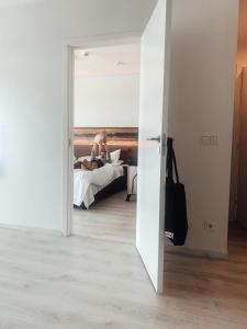 a man sitting on a bed in a room at Ö Seaside Suites & SPA in Kuressaare