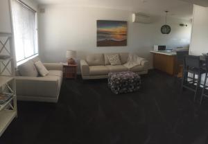 a living room with a couch and a table at Old Pier Apartments in Bridport