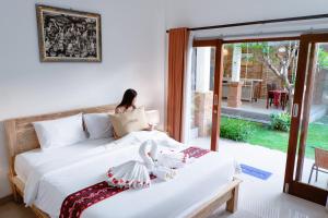 a woman sitting on a bed in a room at Agatha Canggu in Canggu +61 photos