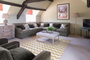 a living room with a couch and a table at Crucis Park Estate in Cirencester