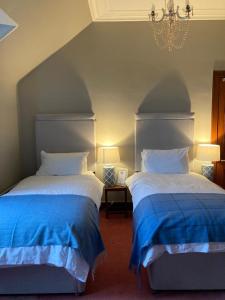 two beds sitting next to each other in a bedroom at Brooklynn Guest House in Grantown on Spey