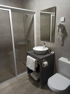 a bathroom with a shower and a sink and a toilet at Porto D'Abrigo - Alojamento Local in Sardoal +30 photos