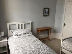 1 dormitorio con 2 camas y mesa de madera en Luxury City Centre Apartment, Exeter. en Exeter