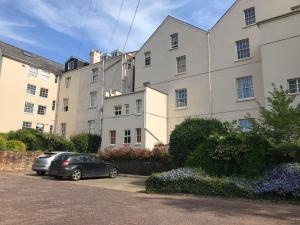 a car parked in a parking lot in front of a building at Luxury City Centre Apartment, Exeter. in Exeter