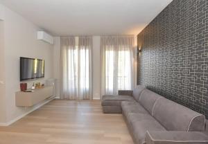 a living room with a couch and a brick wall at CASA DOM-PEDRO in Rivarolo Canavese