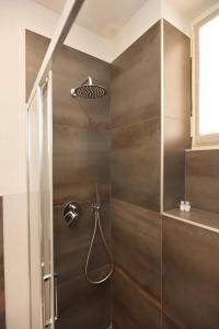 a shower with a shower head in a bathroom at CASA DOM-PEDRO in Rivarolo Canavese