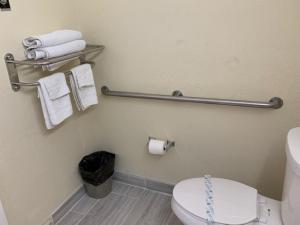 a bathroom with a white toilet and towels at Americas Best Value Inn and Suites -Yucca Valley in Yucca Valley