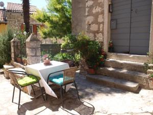stół i krzesła na dziedzińcu ze schodami w obiekcie Apartment MONTE w Rovinj