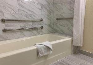 a bathroom with a bath tub and a towel at Americas Best Value Inn and Suites -Yucca Valley in Yucca Valley