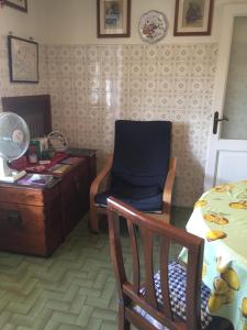 a room with a table and a chair and a desk at LA BARRIERA affittacamere in Florence