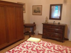 a bedroom with a bed and a dresser and a window at LA BARRIERA affittacamere in Florence
