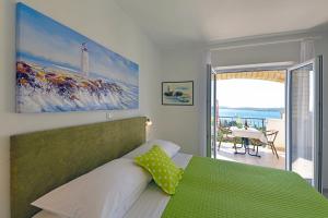 a bedroom with a bed and a view of the ocean at Apartments Tamara in Hvar