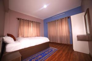 
A bed or beds in a room at Himalayan Sweet Apartment and Homestay
