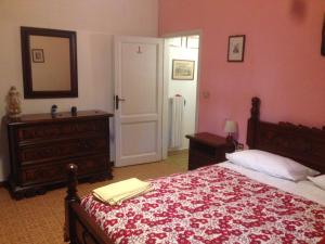 a bedroom with a bed and a dresser and a mirror at LA BARRIERA affittacamere in Florence