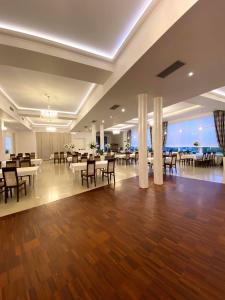 a banquet hall with tables and chairs in a building at Hotel Magnolia in Kielce
