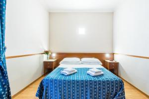 Postel nebo postele na pokoji v ubytování Hotel Tempio Di Pallade