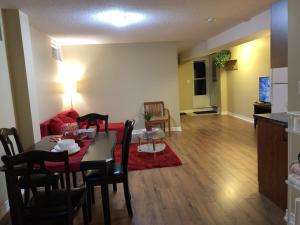 a dining room and living room with a table and chairs at Spacious 2 Bedroom guest suite in Toronto