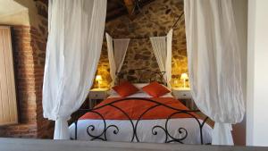 a bedroom with a bed with white curtains at Casas del Castillo, 2 in Avila