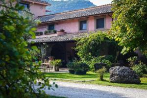 a house with a gravel road in front of it at La Chiesuola in Viterbo