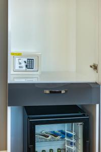 a microwave sitting on top of a table with a drawer at Gloria Suites Old City in Istanbul