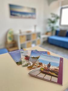 three pamphlets sitting on top of a table at Casa Algarve in Portimão