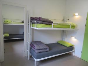 a room with three bunk beds and a blue cushion at Alberg la Bruna in Bellver de Cerdanya  +203 photos