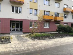 an apartment building with a courtyard in front of it at Apartment Oltec in Bohunice