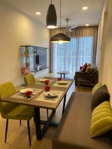 a living room with a table and a couch at Genting Windmill Amazing Sky Pool 2bedroom With Aircon Wi-Fi in Genting Highlands +30 photos