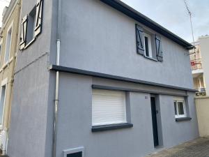 a gray building with windows and a door at Maison cœur de ville esprit industriel - Le Loft12 in Châteauroux