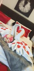 Una cama con dos corazones y flores. en Studio Appartement en Speichersdorf