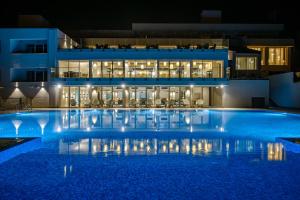 a large swimming pool in front of a building at night at Hotel Sunce in Soko Banja
