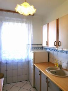 a kitchen with a sink and a window at Apartament SIELANKA PARK in Łódź +8 photos