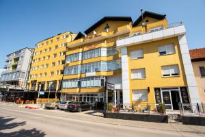 a yellow building on the side of a street at HOTEL Villa Grande in Bugojno