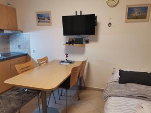 a room with a table and a bed and a kitchen at Apartma Gaber 80 in Zreče