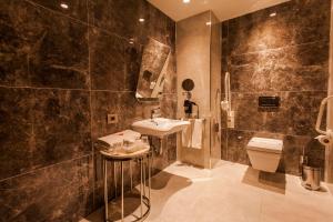 a bathroom with a sink and a toilet at Holiday Inn Kayseri - Duvenonu, an IHG Hotel in Kayseri