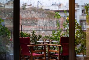 a table and chairs on a balcony with a view at Urban Donkey in Thessaloniki