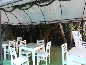 a group of white tables and chairs under a tent at Arenas Hotel & Spa in Tacna