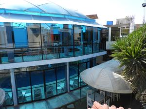 an external view of a building with a swimming pool at Arenas Hotel & Spa in Tacna