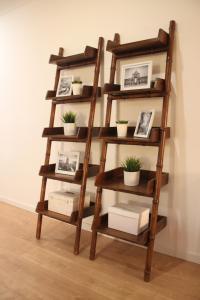 a wooden shelf with plants and pictures on it at RomanticHome at Alfama's Heart in Lisbon