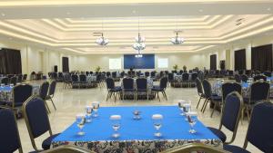 a banquet hall with tables and chairs and a podium at Taman Bukit Palem Resort in Bogor