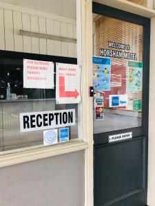 a store front with signs on the window at Horsham Motel in Horsham