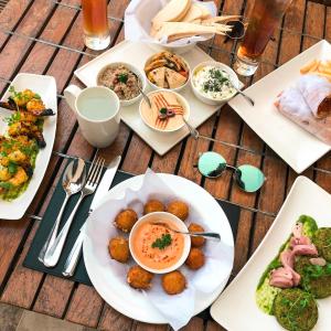 a wooden table with plates of food on it at Prince Hotel Mallroad in Mussoorie