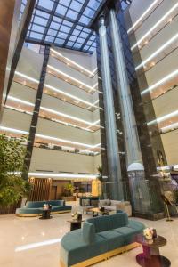 een lobby met blauwe banken en tafels in een gebouw bij Art View Hotel Al Riyadh in Riyad