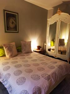 
a bedroom with a bed and a lamp at La Maison Rouge in Paris
