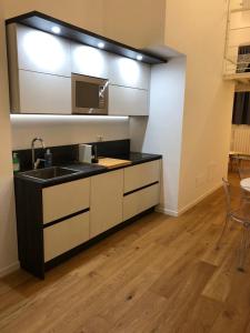 a kitchen with a sink and a microwave at Savoia 19 in Milan