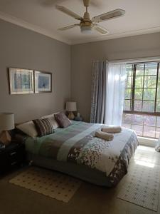 a bedroom with a large bed and a window at Charming country house close to Grafton in Waterview Heights